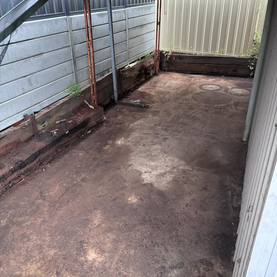 The same side passage emptied down to bare earth and the retaining wall